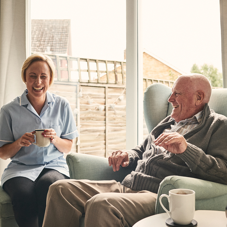 image of an elderly father having coffee with his daughter