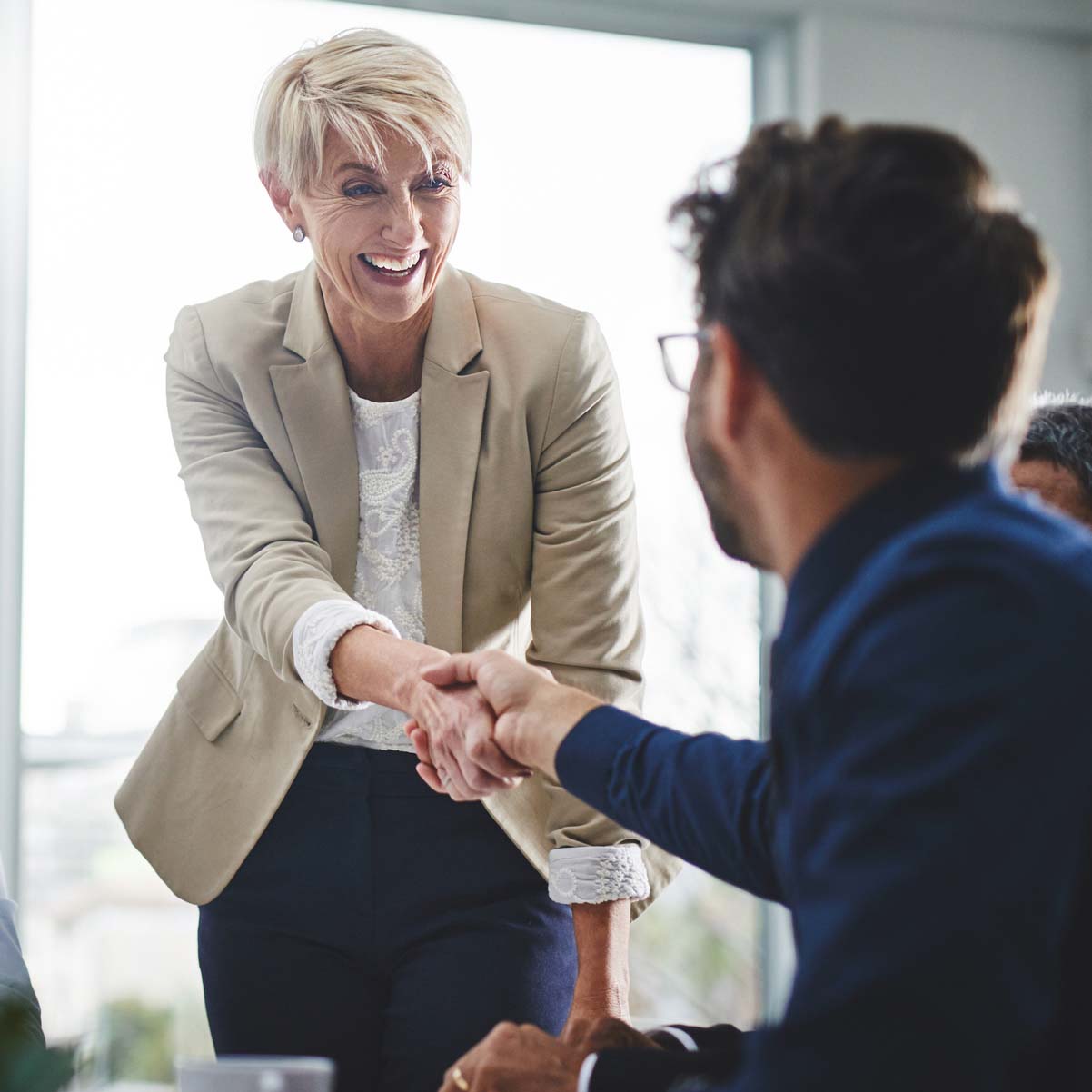 woman and man shaking hands